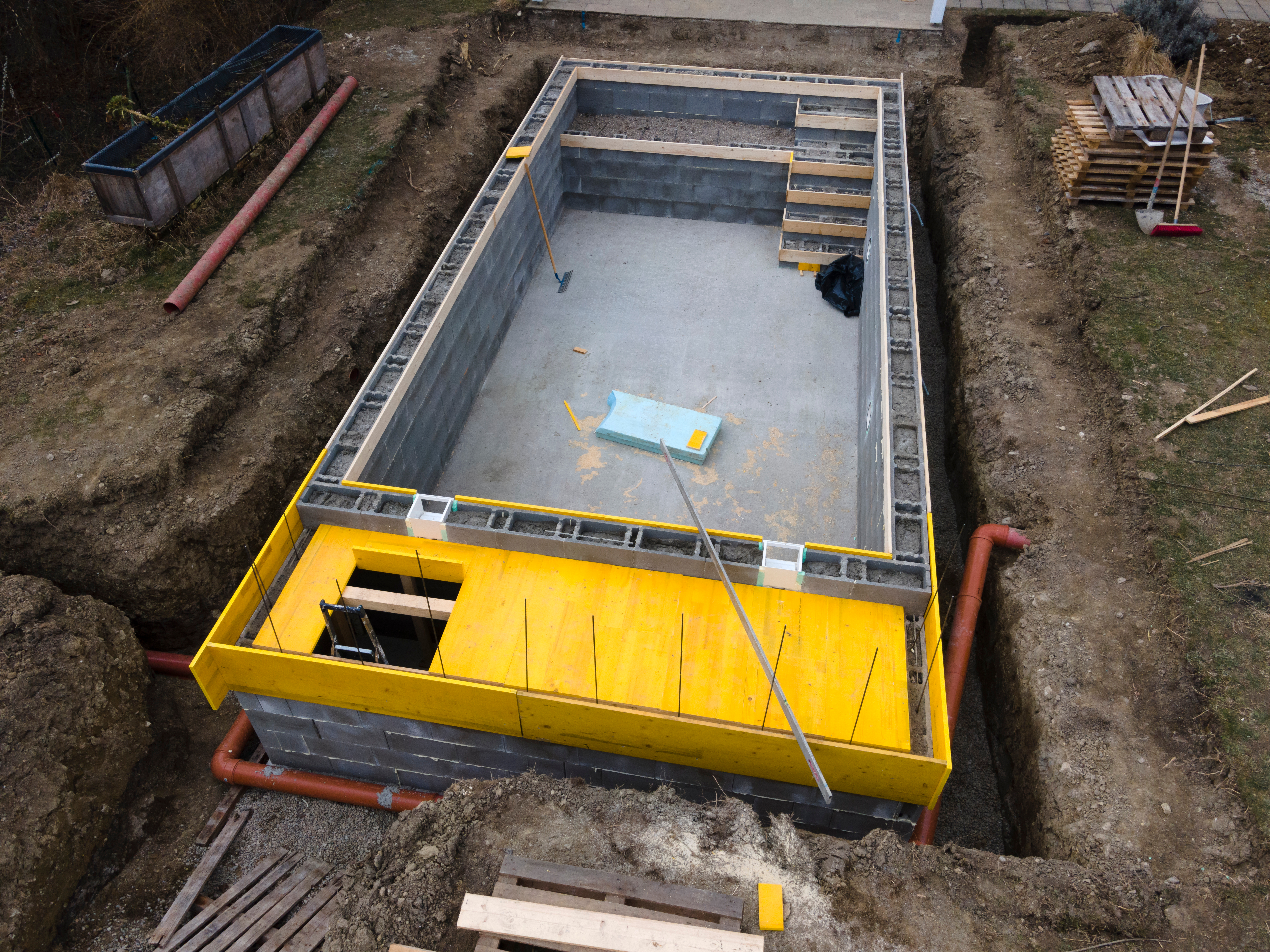aerial,drone,shot,of,construction,site,from,pool,with,formwork aerial,drone,shot,of,construction,site,from,pool,with,formwork
